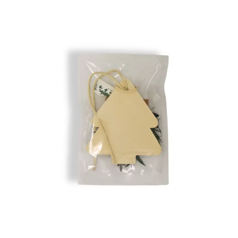 Back view of beige Christmas tree air freshener in vacuum bag